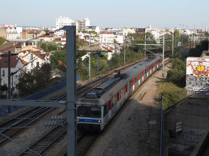 Railway tracks near La Défense, with graffiti on the concrete walls
